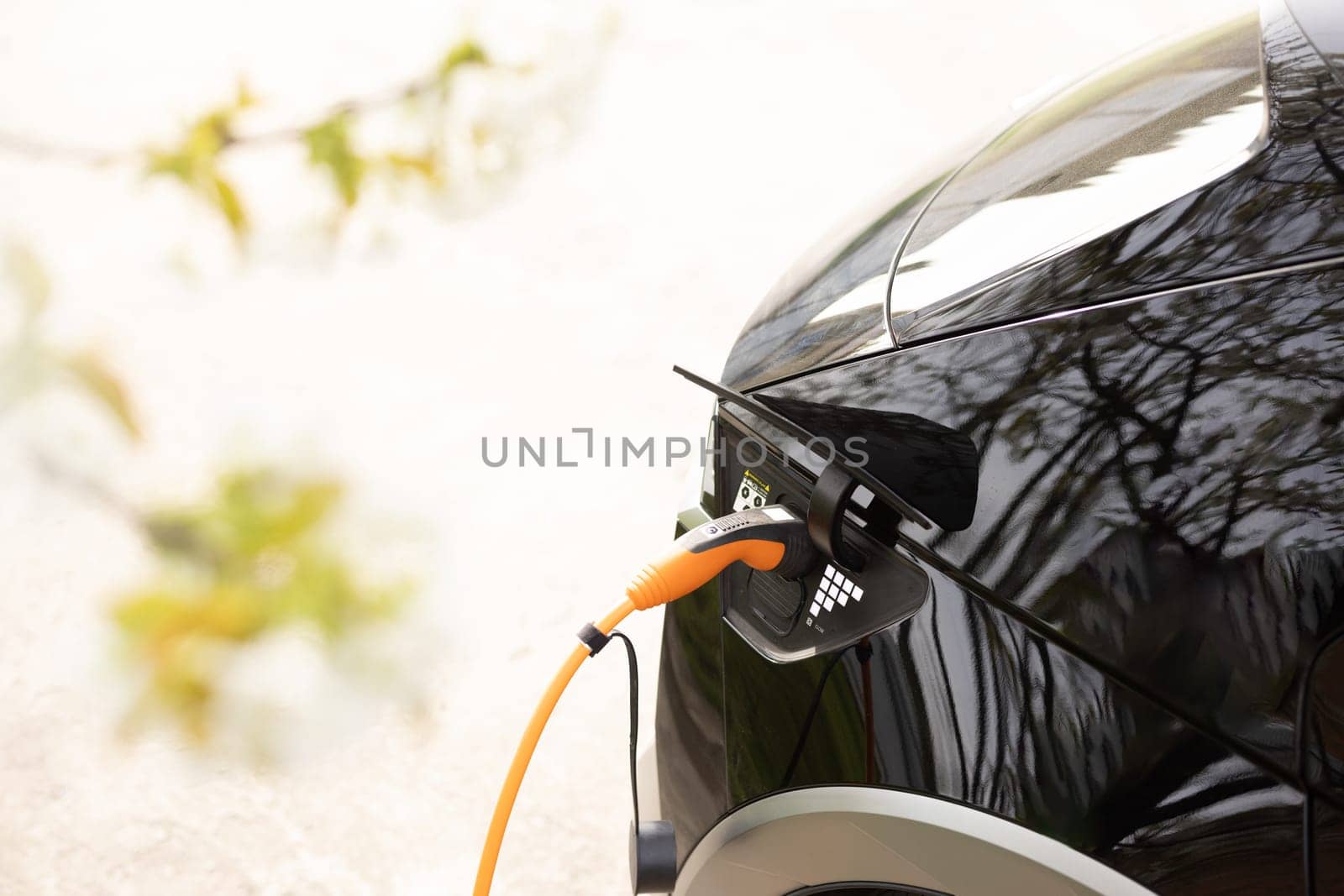 Electric vehicle charging port plugging in car. Charging technology, Clean energy filling technology. Electric car charging by uflypro