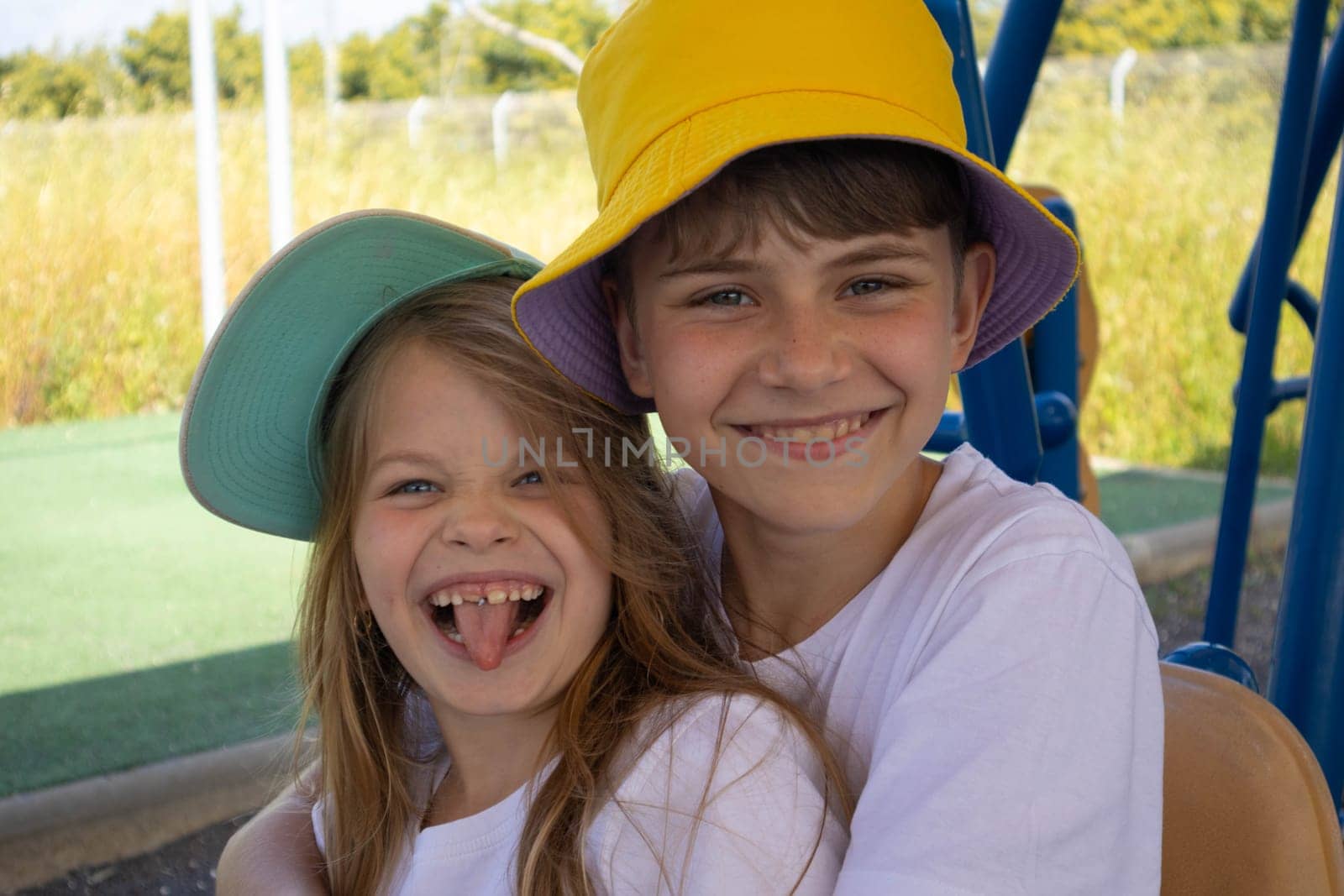 Cheerful boy and girl in hats. High quality photo