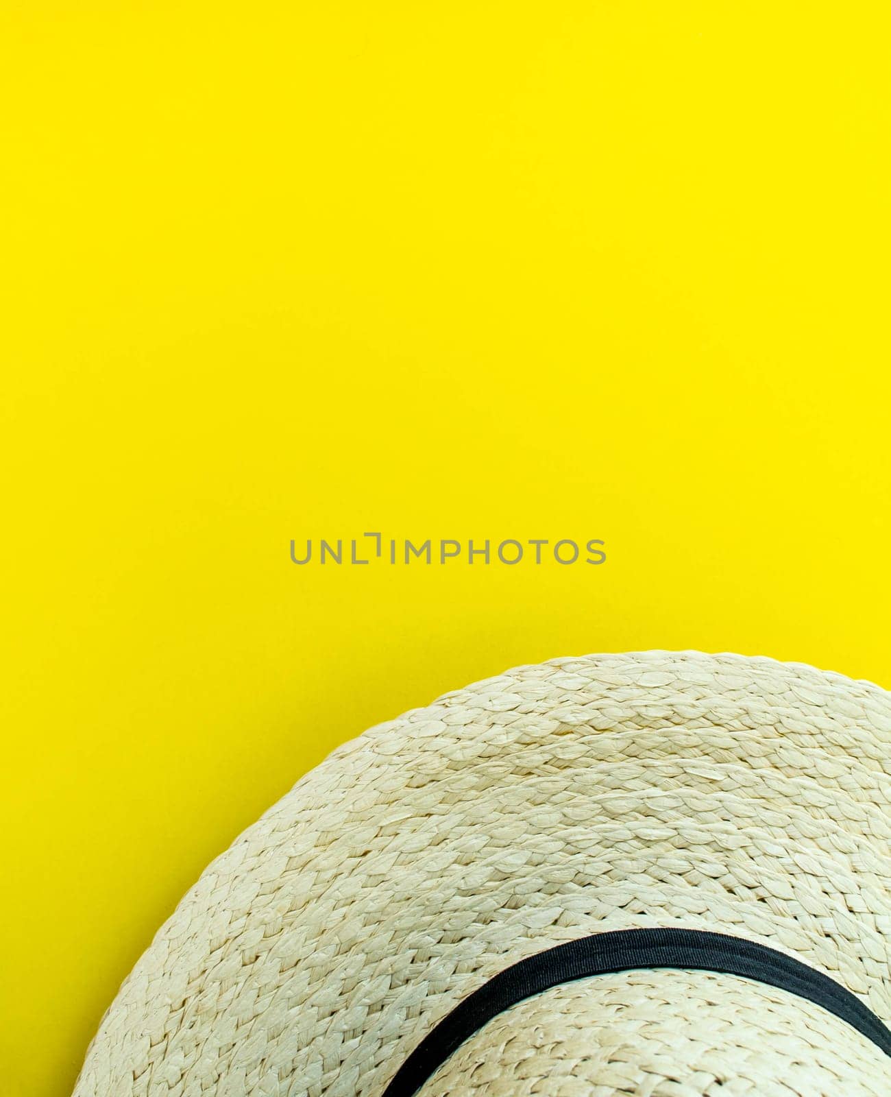 Flatlay, summer vacation. Straw hat on a yellow background. Vertical background.  by Yuka777