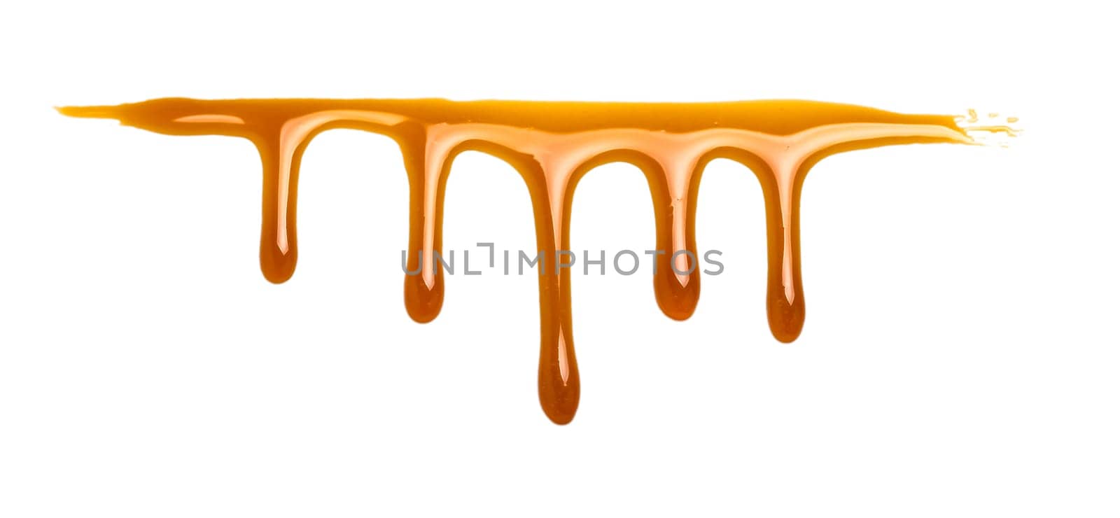 sweet caramel sauce isolated on white by fascinadora