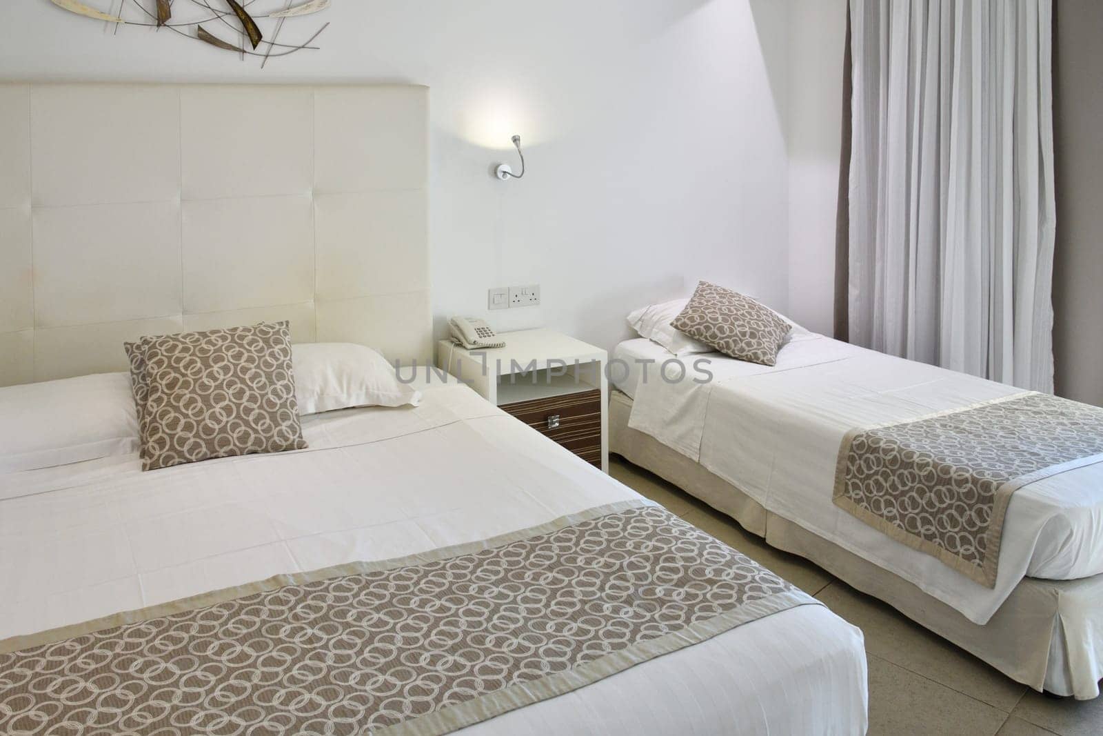 Interior of a hotel room with a two beds