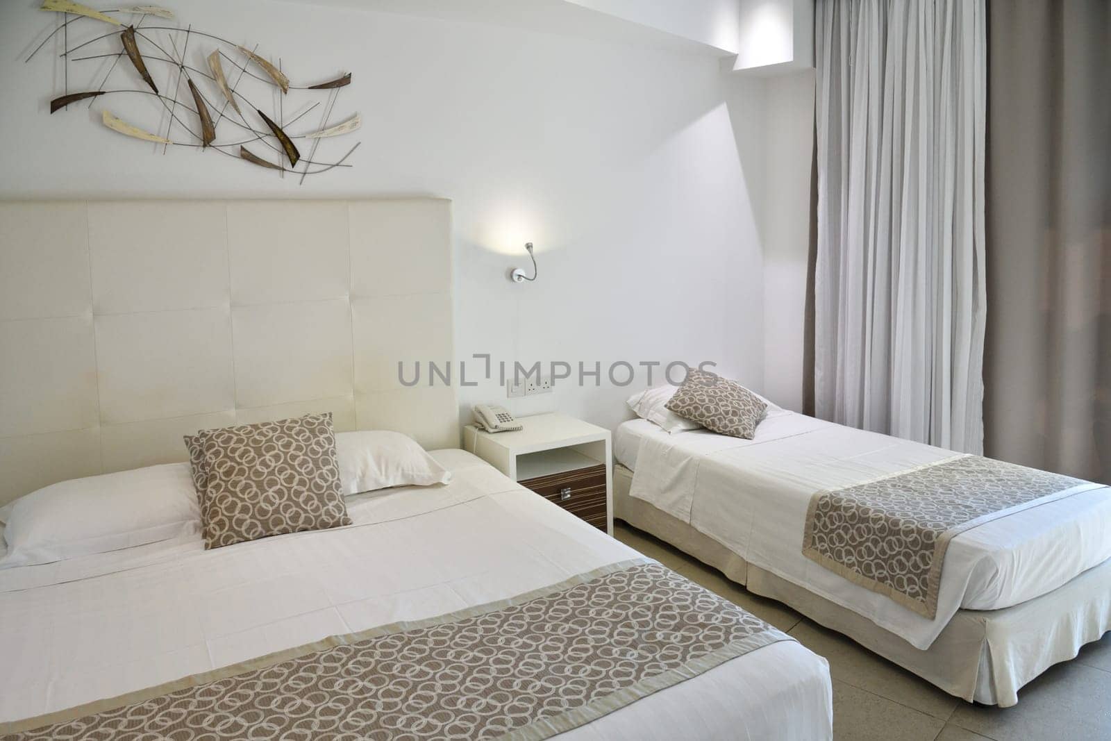 Interior of a hotel room with a two beds