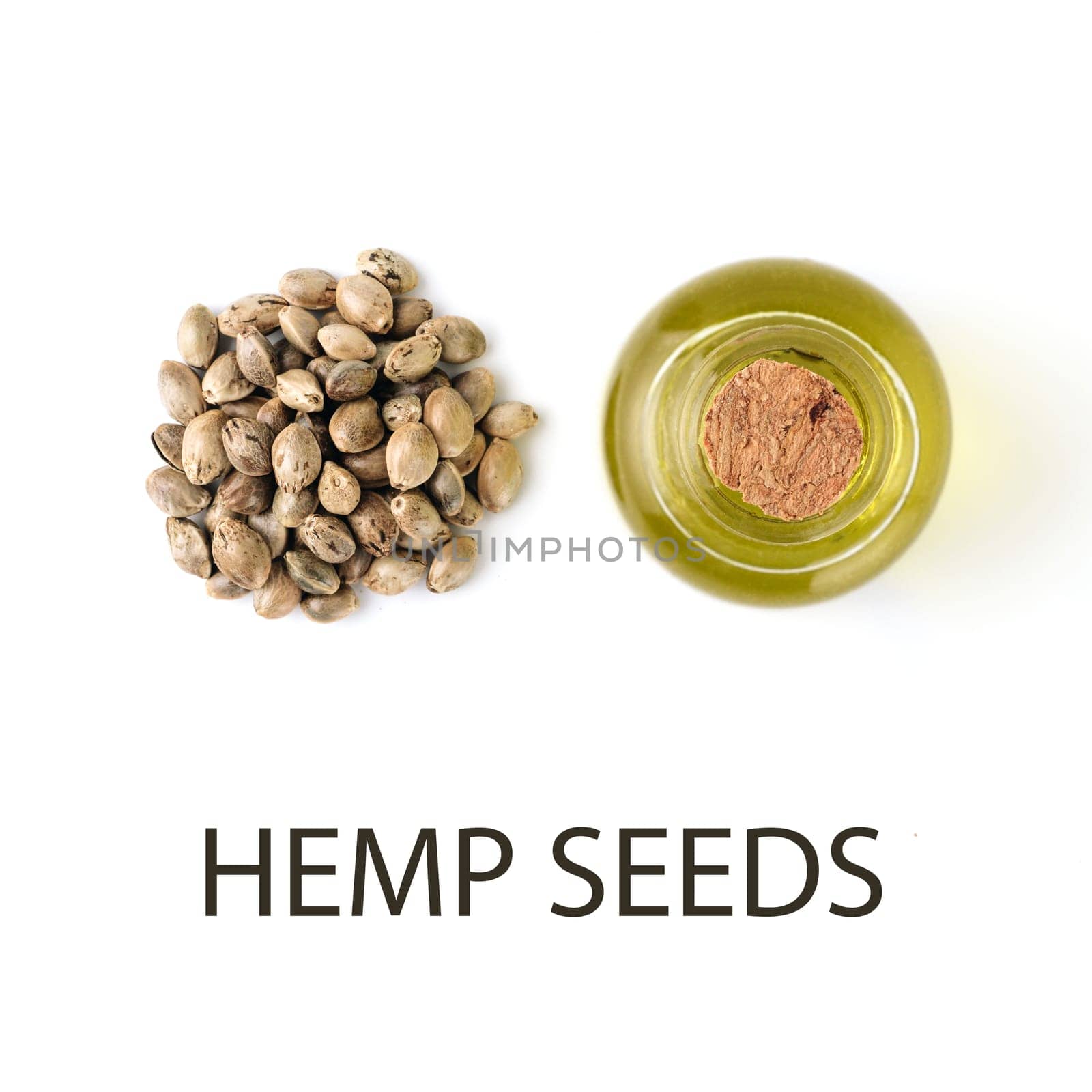 Hemp seeds and Hemp raw oil isolated on white background. Heap of hemp seeds and raw hemp oil in small glass bottle - creative layout. Isolated on white with clipping path, top view or flat lay. Macro