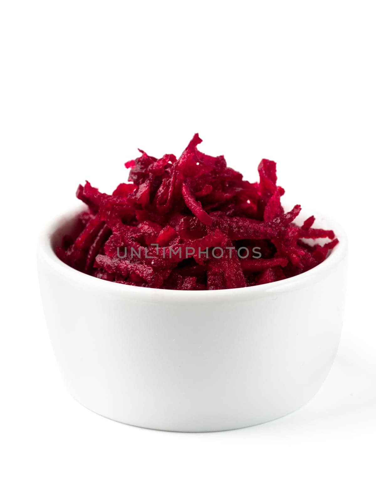 Grated beetroot in ceramic bowl. Shredded beet root salad isolated on white