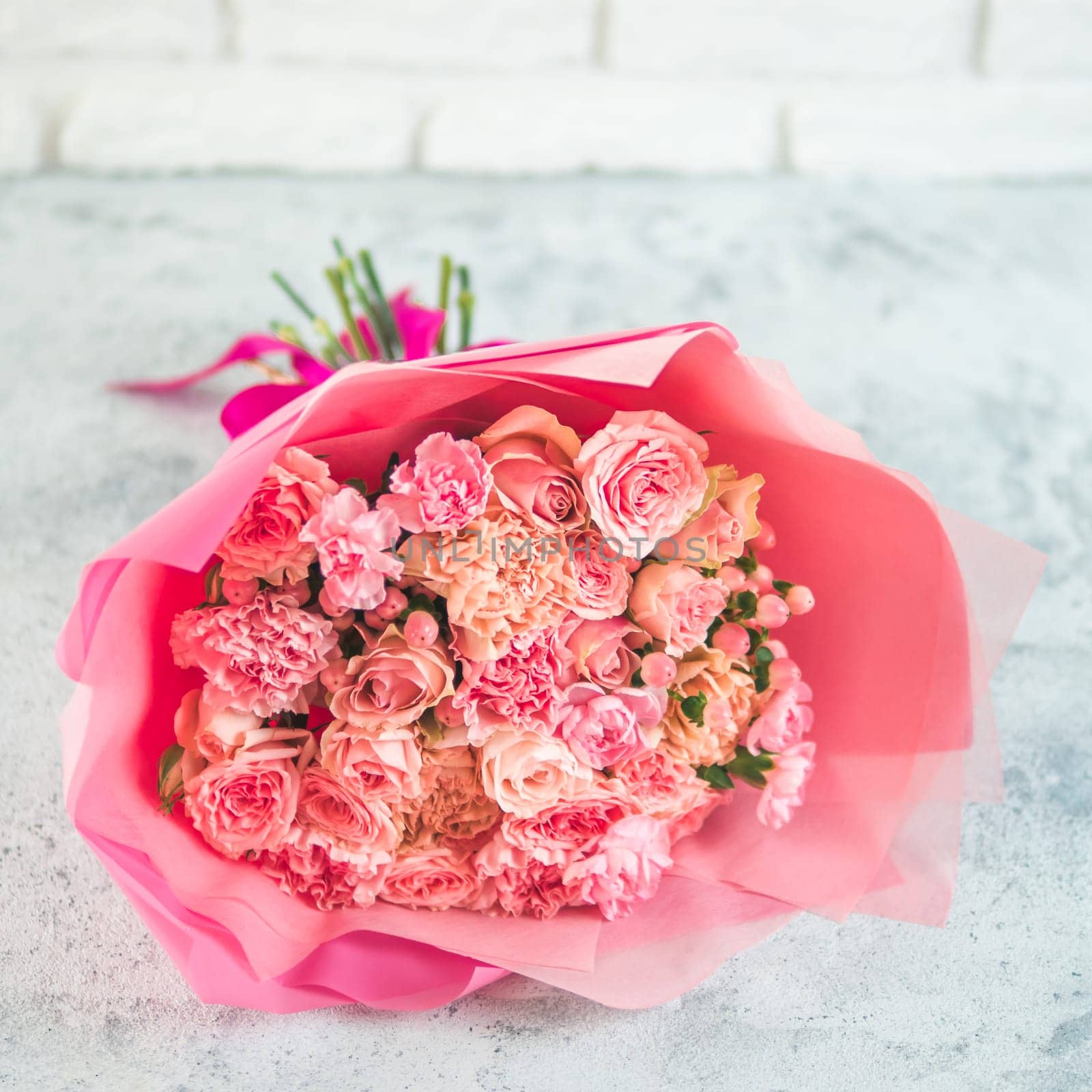 Close up view of nice subtle delicate pink bouquet with roses, dianthus, hypericum, clove. Shallow DOF. Copy space for text.