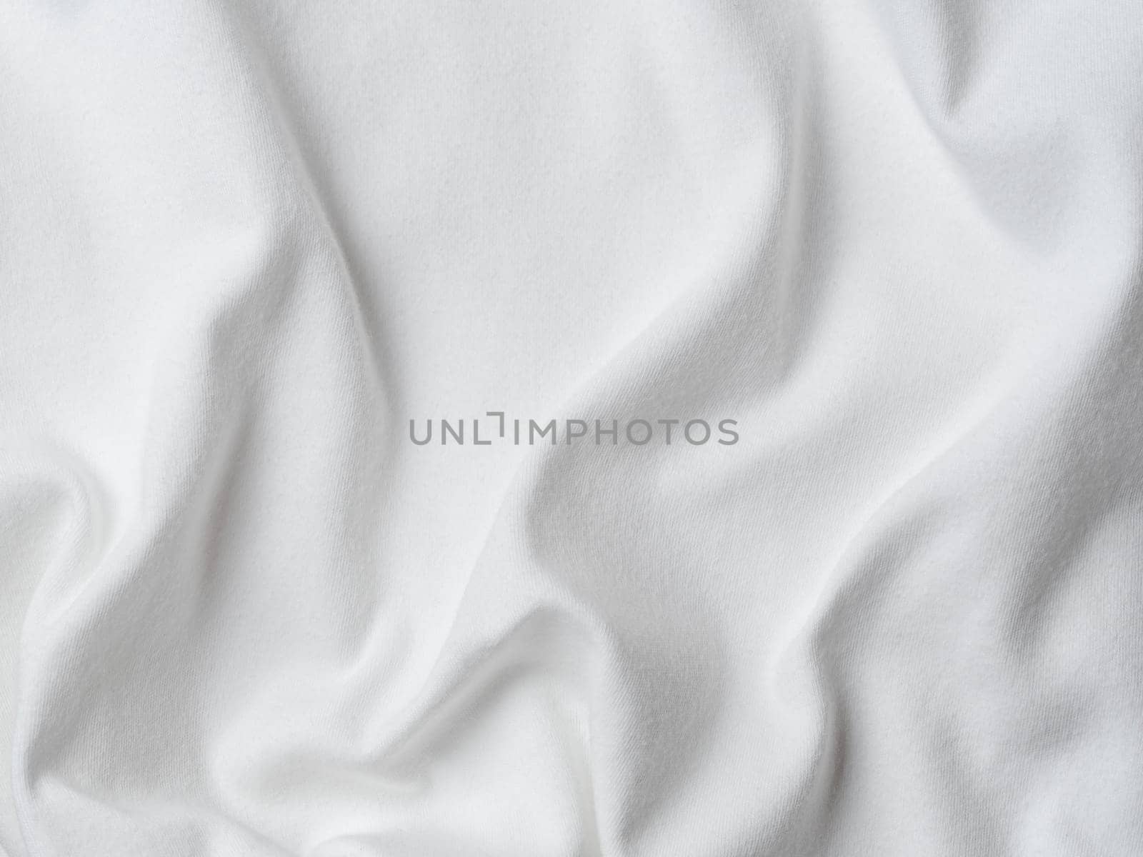 White cotton fabric texture. Clothes cotton jersey background with folds