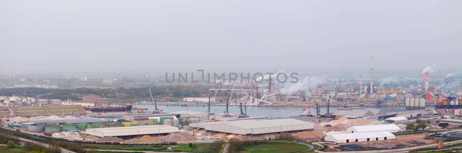 Panorama of hydrocarbon refinery and liquefied natural gas tanks at overcast day by Robertobinetti70
