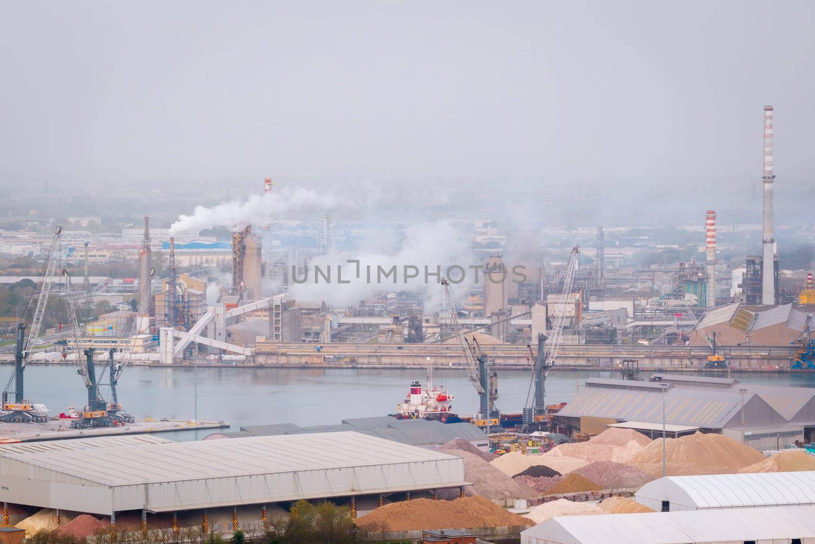 drone view of hydrocarbon refinery and liquefied natural gas tanks at cloudy day by Robertobinetti70