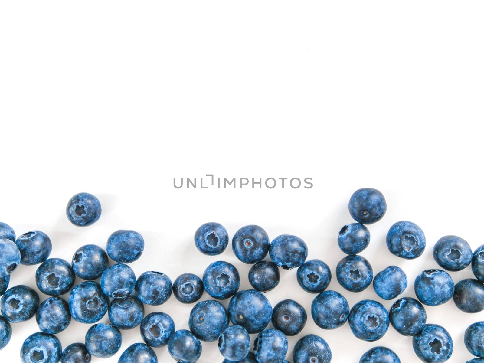 Creative layout with fresh ripe berries. Blueberry isolated on white background with copy space. Can use for your design, promo, social media. Top view.