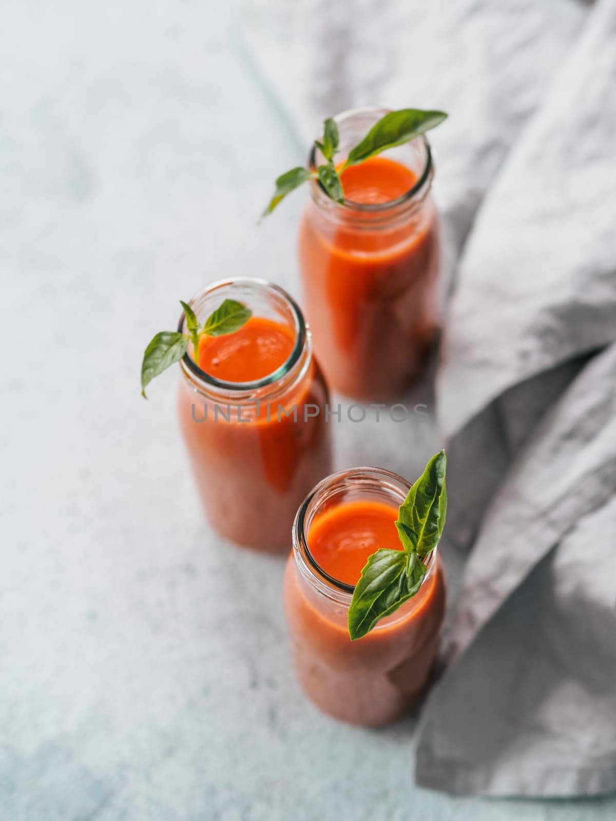 Gaspacho soup in glass bottles, vertical by fascinadora