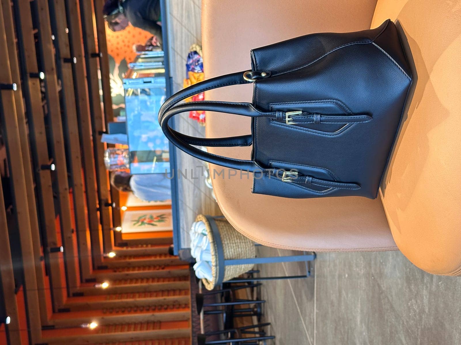 Black handbag on an armchair at the coffee shop