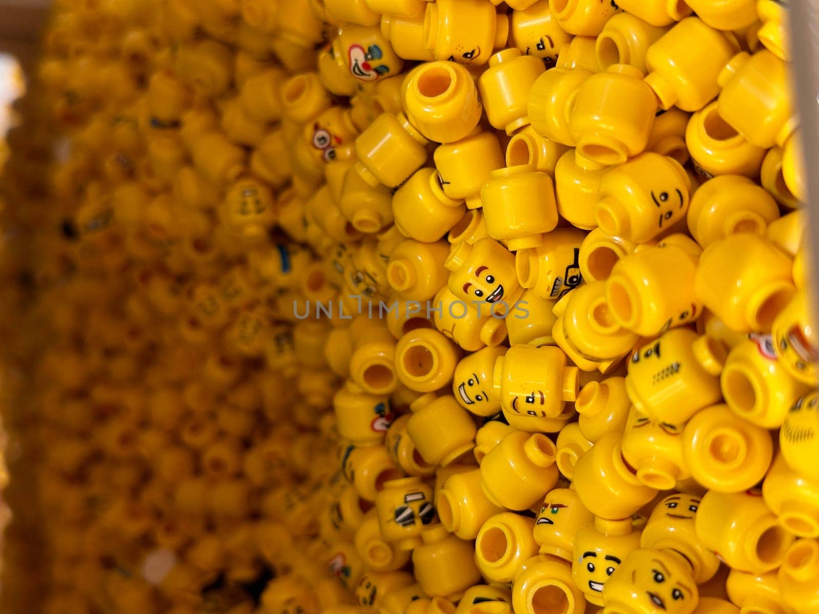 Vertical close up of yellow constructor doll toy heads