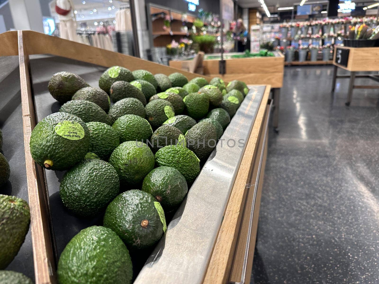 Green avocados for sale at supermarket