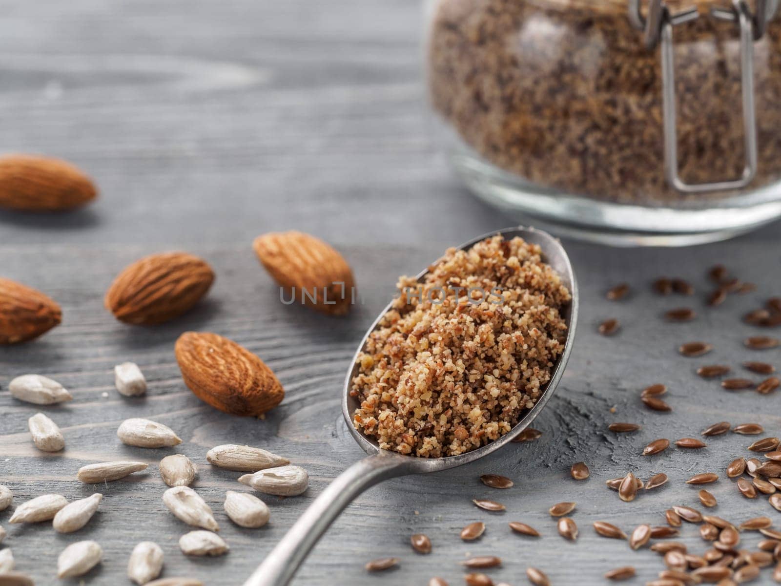 Homemade LSA mix in spoon - Linseed or flax seeds, Sunflower seeds and Almonds. Traditional Australian blend of ground, source of dietary fiber, protein, omega fatty acids. Copy space for text.