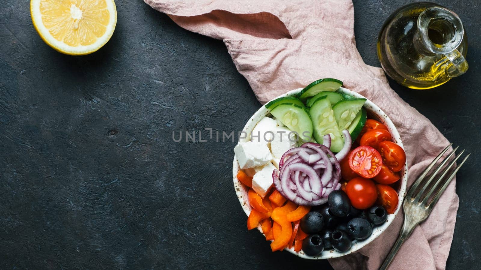 Greek Salad Bowl on dark black background, copy space. Above view of Bowl Greek Salad. Trendy food. Idea, recept and concept of modern healthy food. Banner