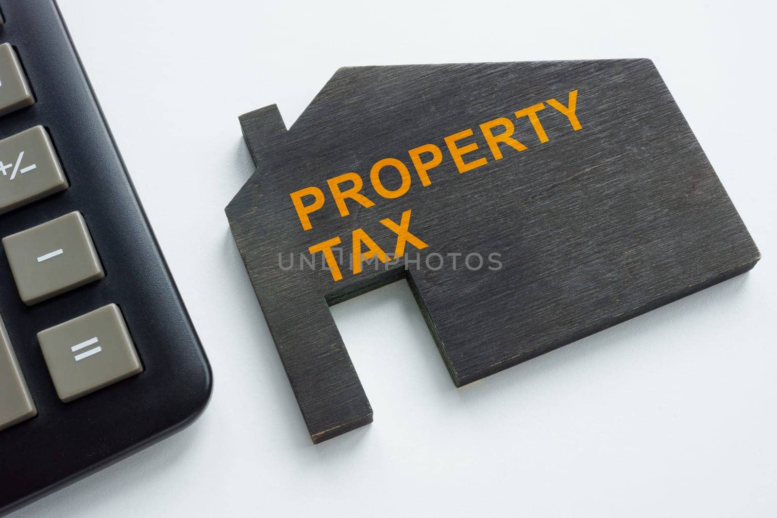 House with inscription Property tax and calculator. by designer491