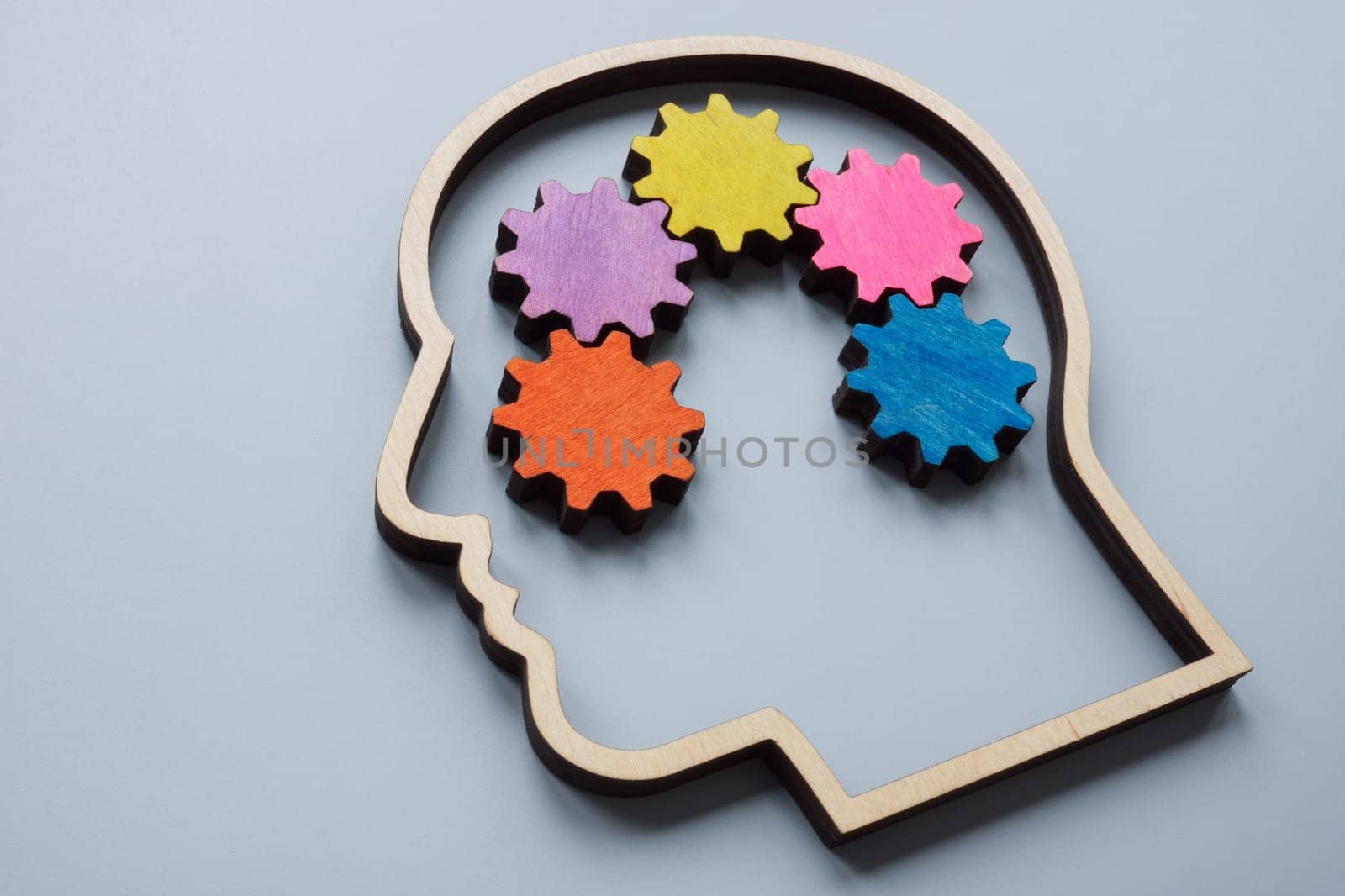 Head outline and colored gears as a concept for lateral thinking, creativity and neurodiversity. by designer491