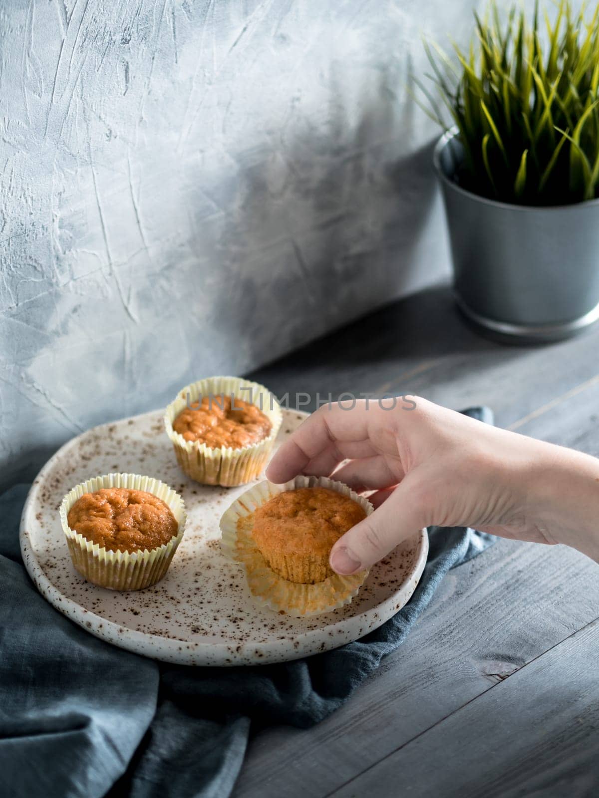 carrot muffins on gray wooden table by fascinadora