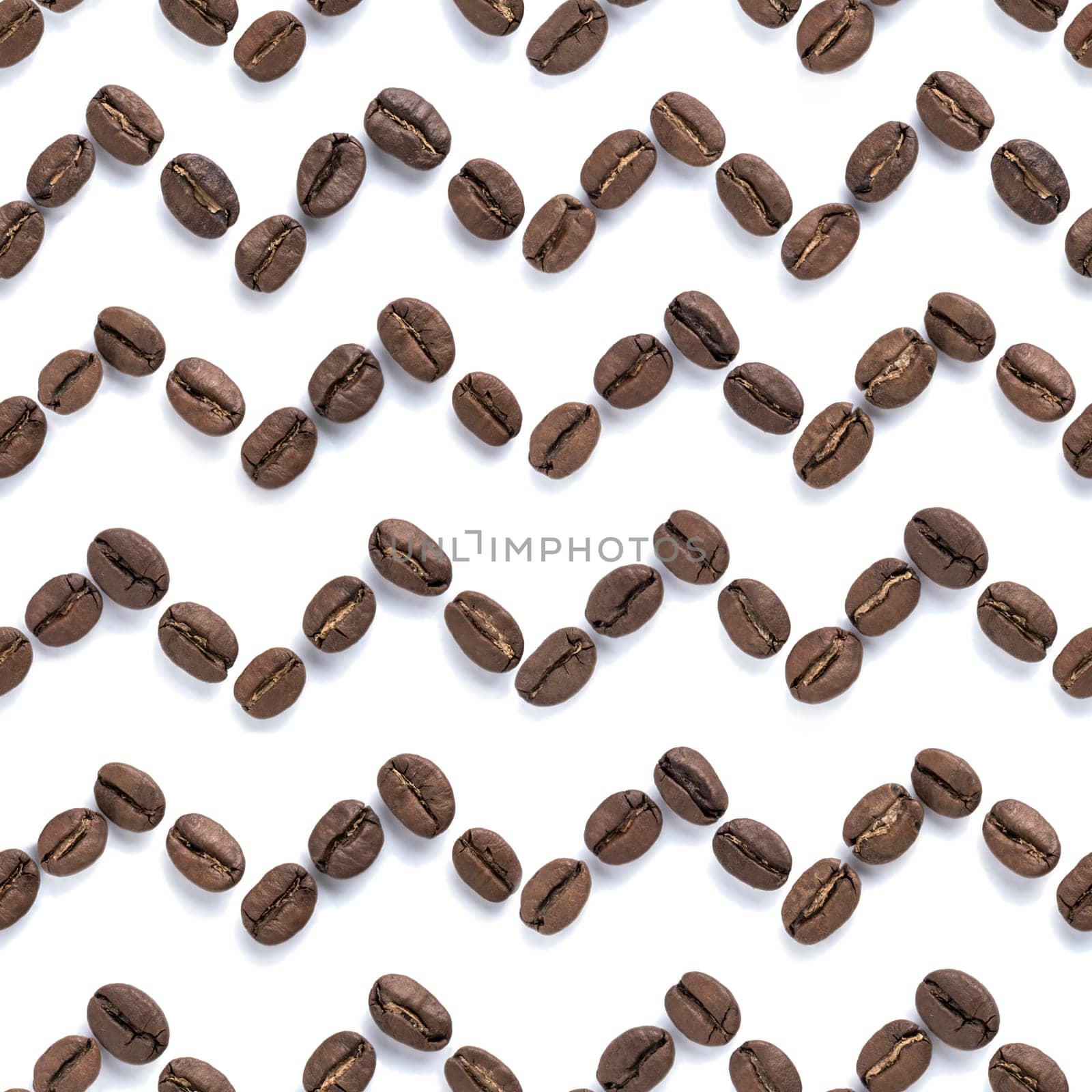 Beautiful trendy zigzag seamless pattern of coffee beans closeup on white background. Coffee border design. Top view or flat lay. Food background