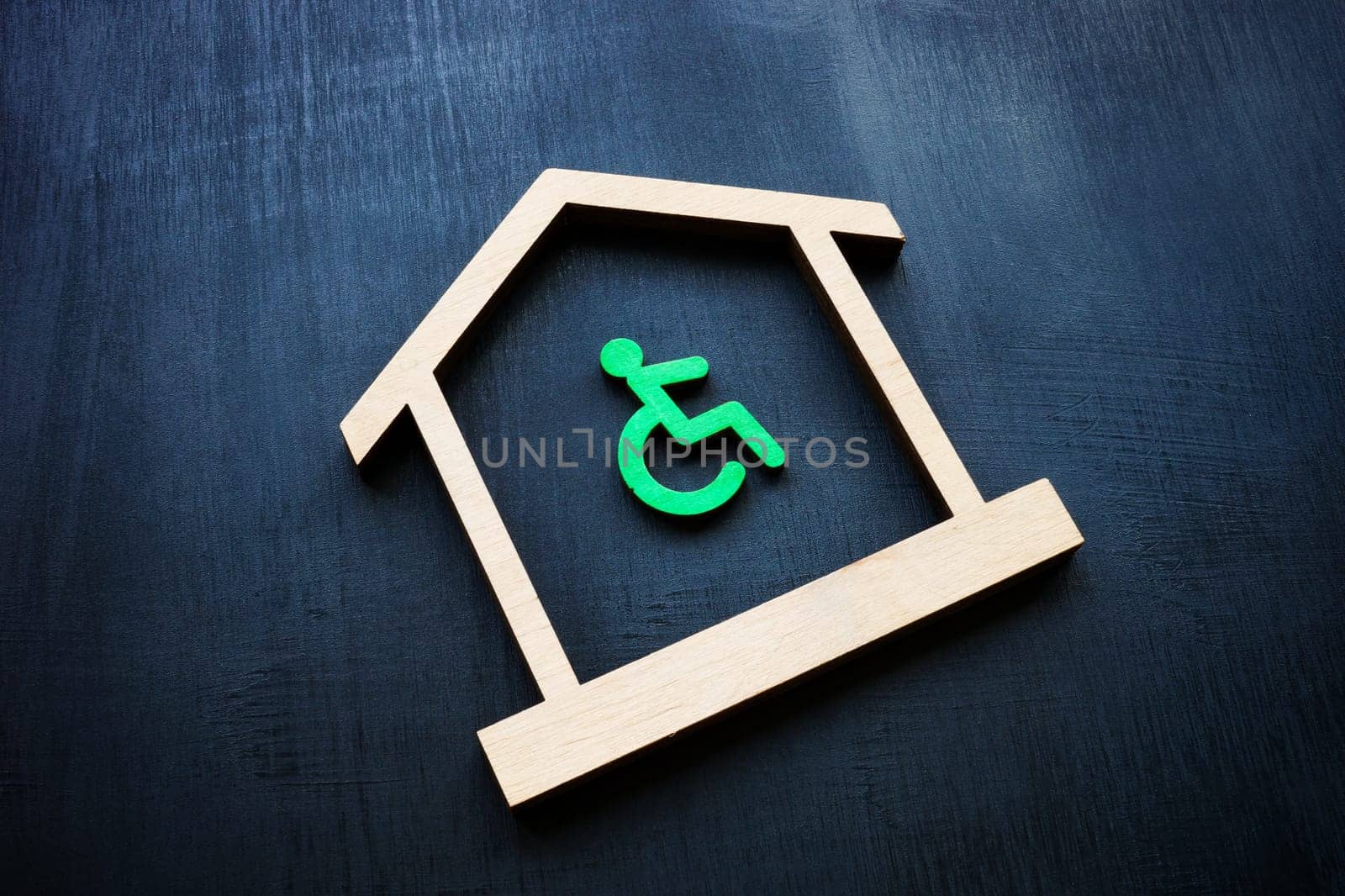 Disabled Person sign and house as a symbol of real estate. Accessible home ownership rights.