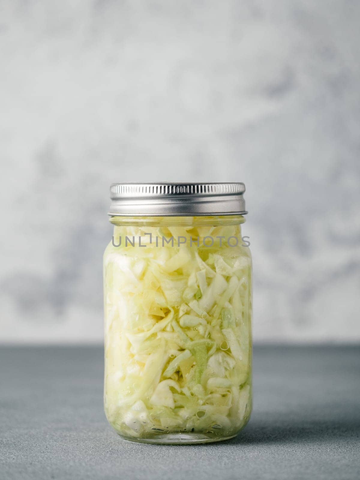 Sauerkraut in open glass jar, copy space by fascinadora