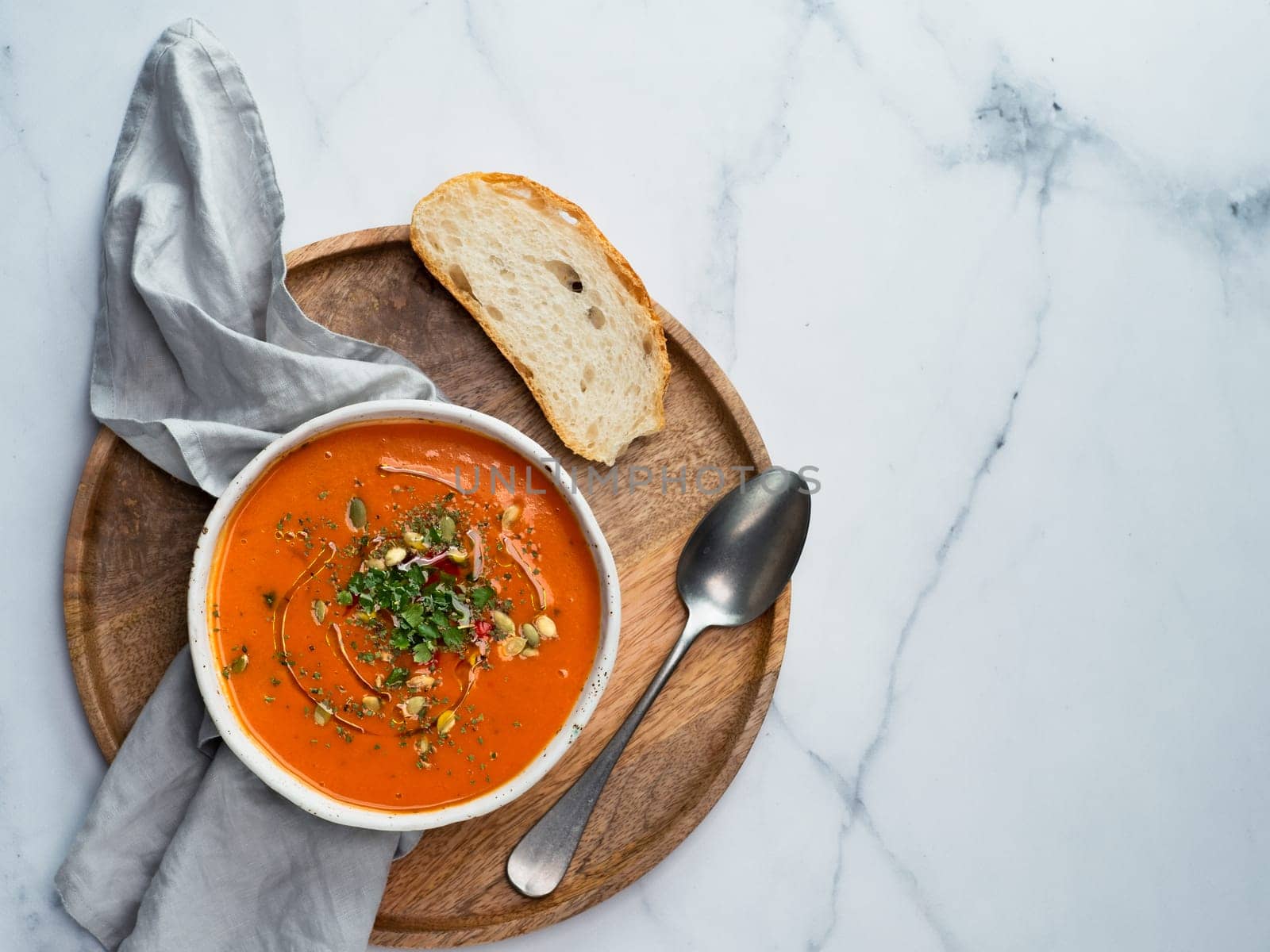 Gaspacho soup on light marble, top view by fascinadora