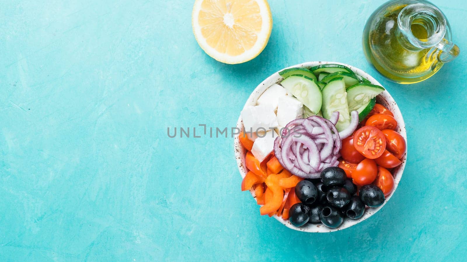 Greek Salad Bowl on blue background, copy space. Above view of Bowl Greek Salad. Trendy food. Idea, recept and concept of modern healthy food. Banner