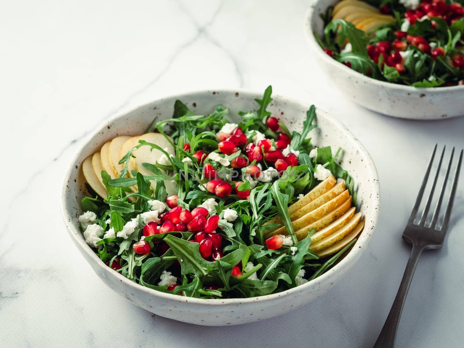 salad with arugula, pear, pomegranate and cheese by fascinadora