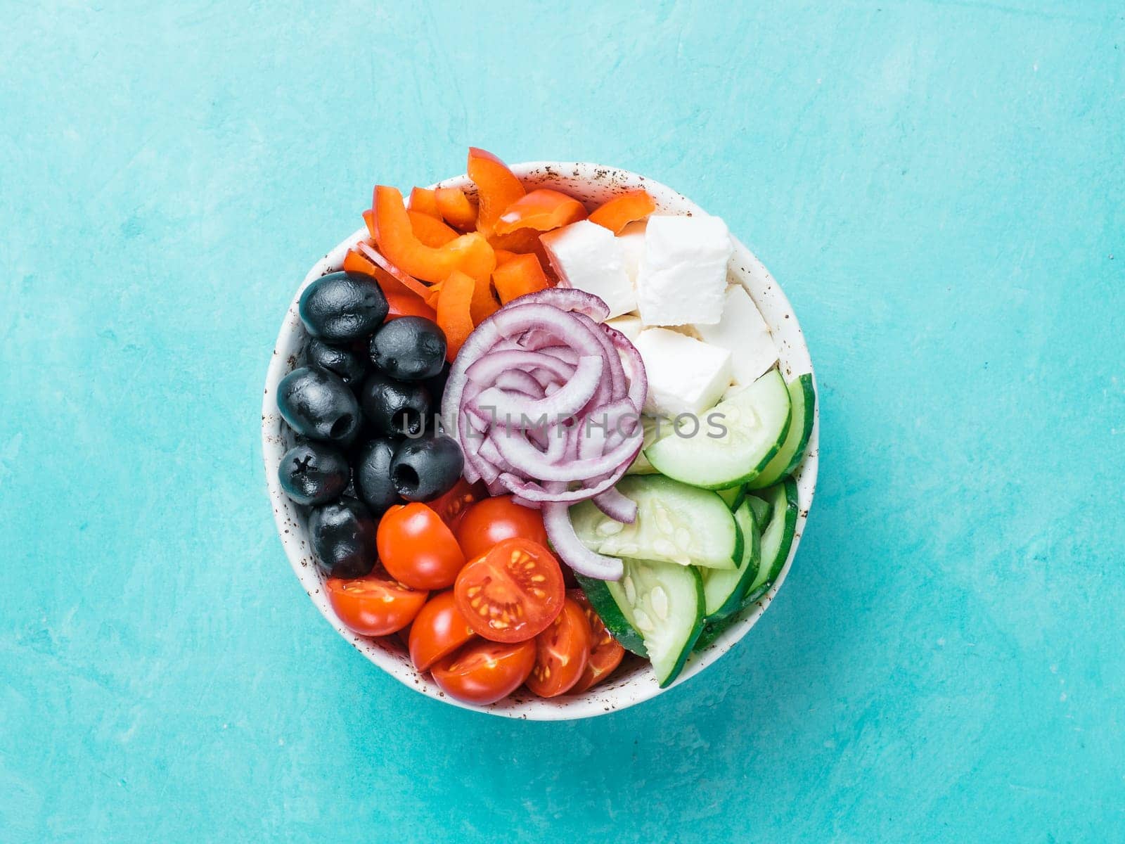 Greek Salad Bowl on blue background, copy space. Above view of Bowl Greek Salad. Trendy food. Idea, recept and concept of modern healthy food. Banner