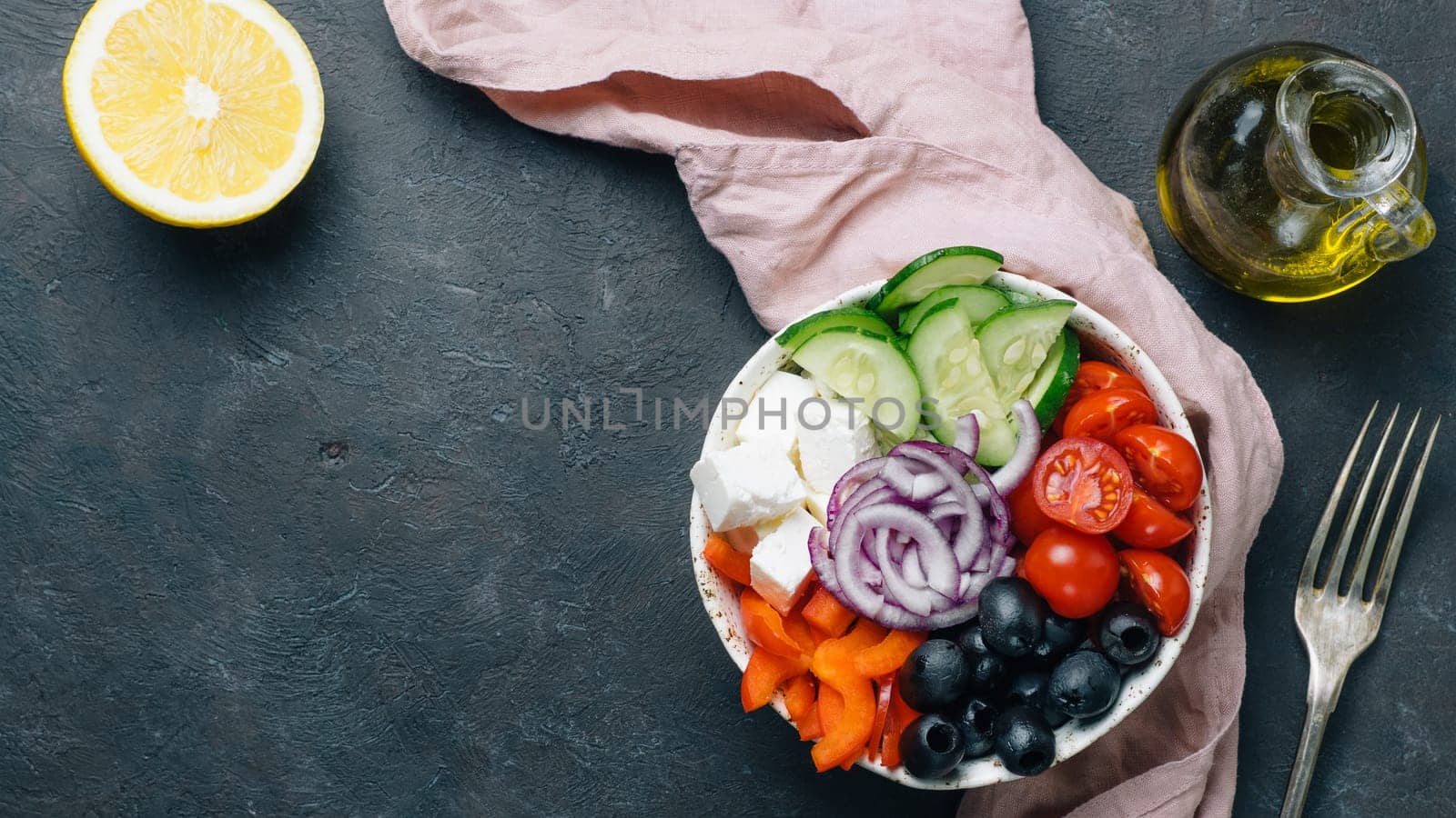 Greek Salad Bowl on dark black background, copy space. Above view of Bowl Greek Salad. Trendy food. Idea, recept and concept of modern healthy food. Banner