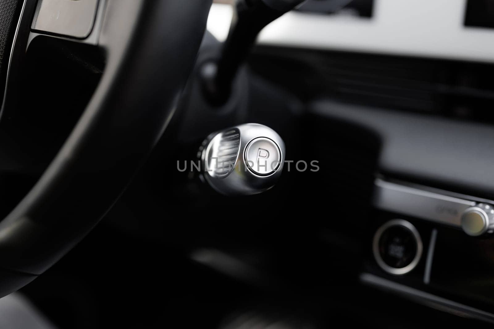Handle of electric car gearbox control. Design details of minimalist concept of electric car - close-up details of automatic transmission and gear stick. Automatic gear lever and gear shift.