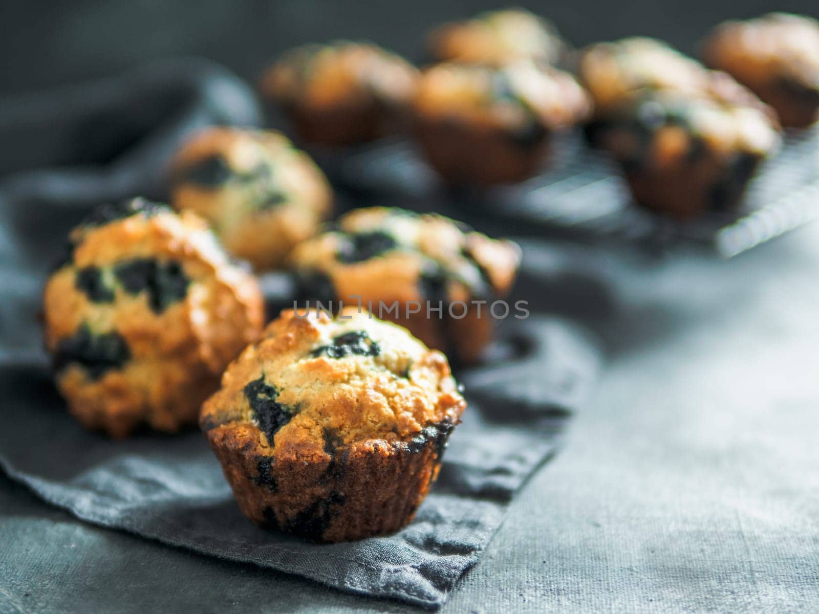 Homemade blueberry muffins on dark background. by fascinadora