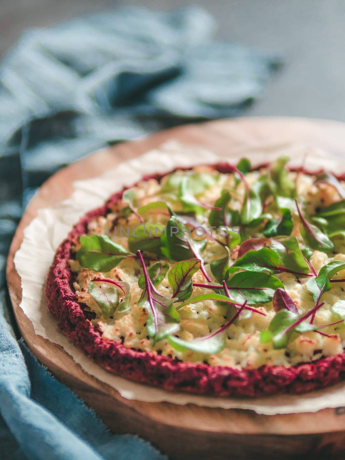 beetroot pizza crust with fresh swiss chard or mangold, beetroot leaves. Ideas and recipes for vegan snack.Egg-free pizza crust with chia seeds and wholegrain brown rice flour. Copy space. Shallow DOF