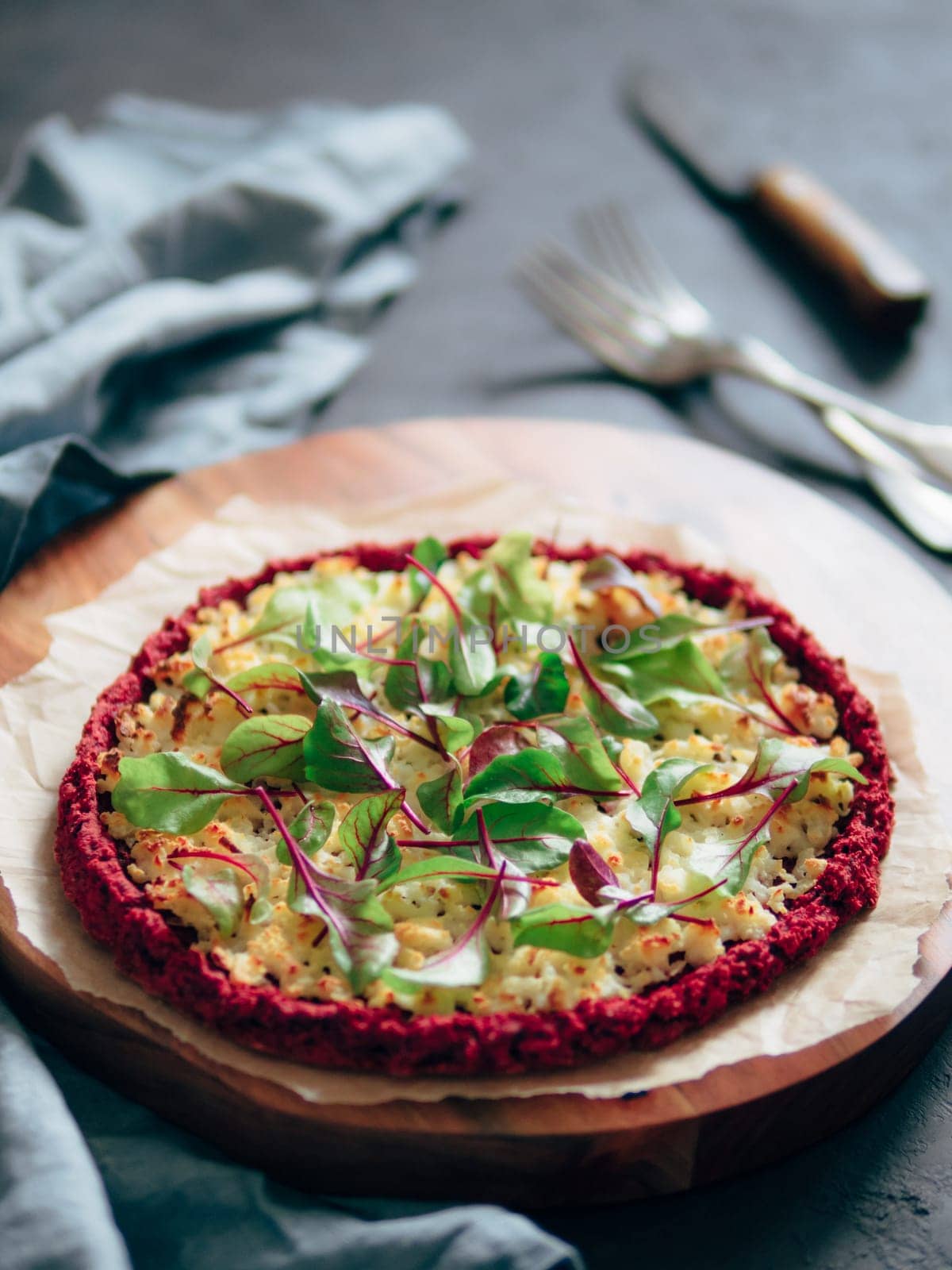 beetroot pizza crust with fresh swiss chard or mangold, beetroot leaves. Ideas and recipes for vegan snack.Egg-free pizza crust with chia seeds and wholegrain brown rice flour. Copy space. Shallow DOF
