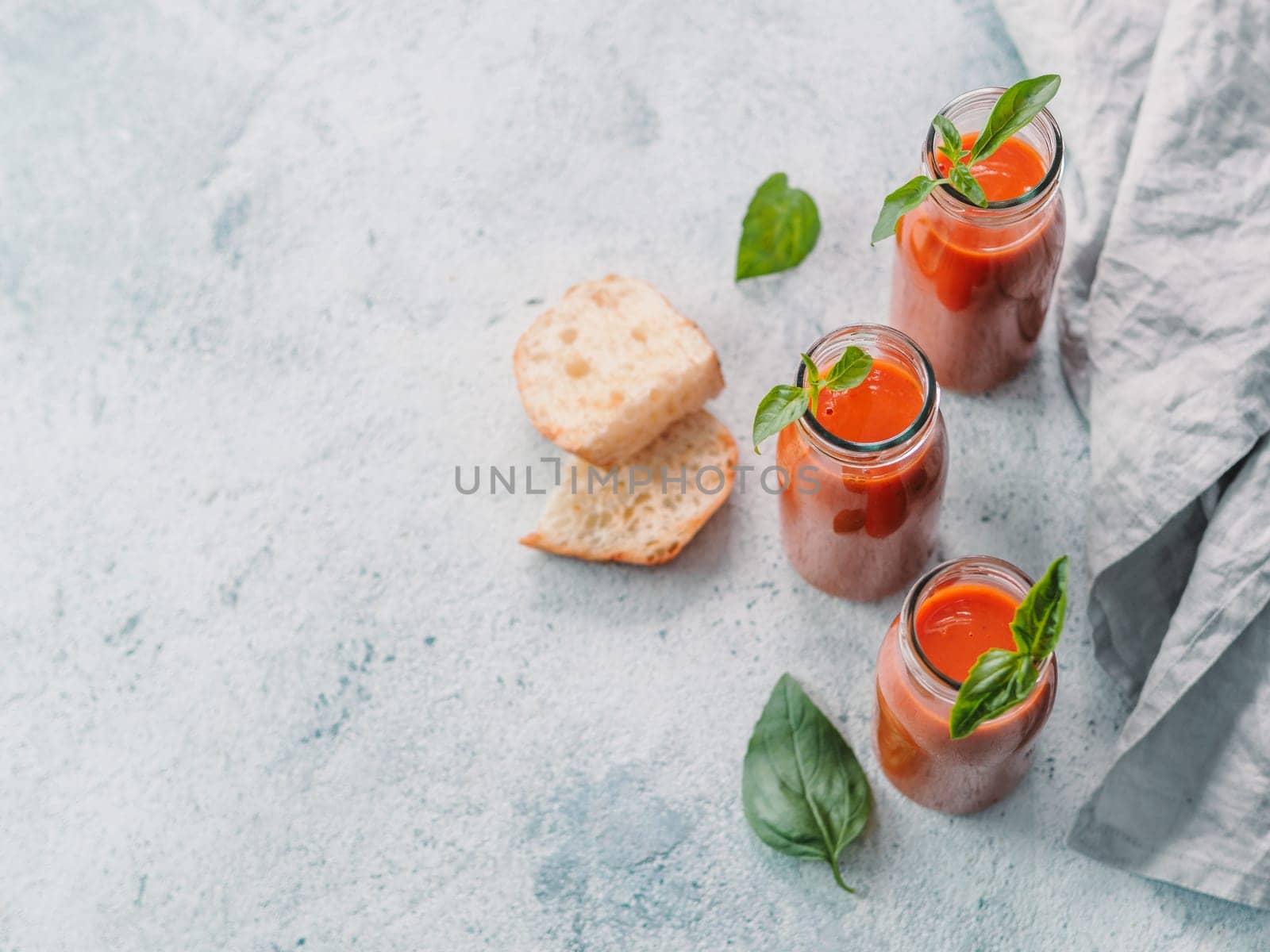 Gaspacho soup in glass bottles, copy space by fascinadora