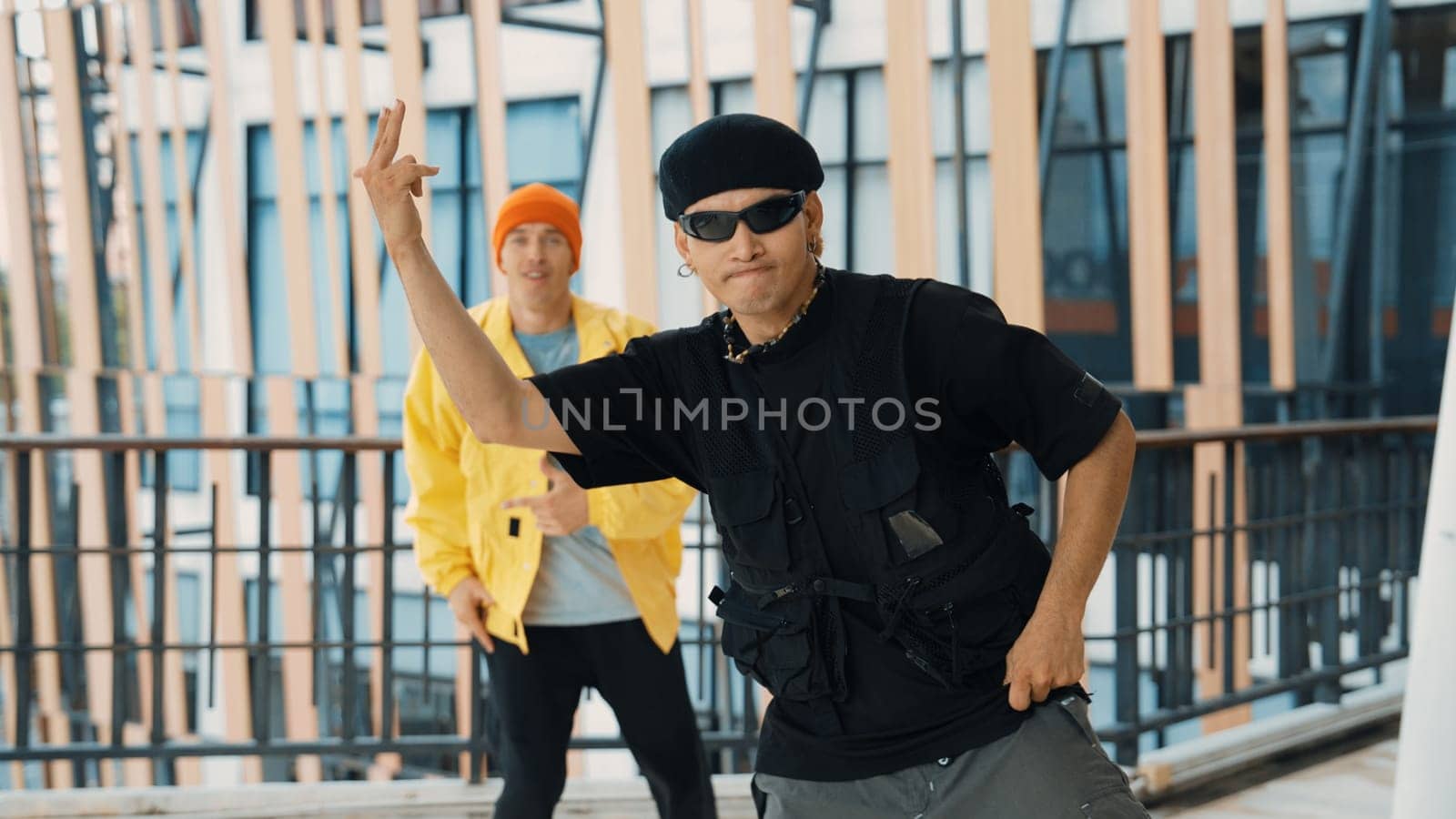 Hipster perform break dancing while partner dancing together at corridor, modern mall. Hip-hop music dancer practice footstep and move to music. Outdoor sport 2024. Active, energetic dance. Endeavor.