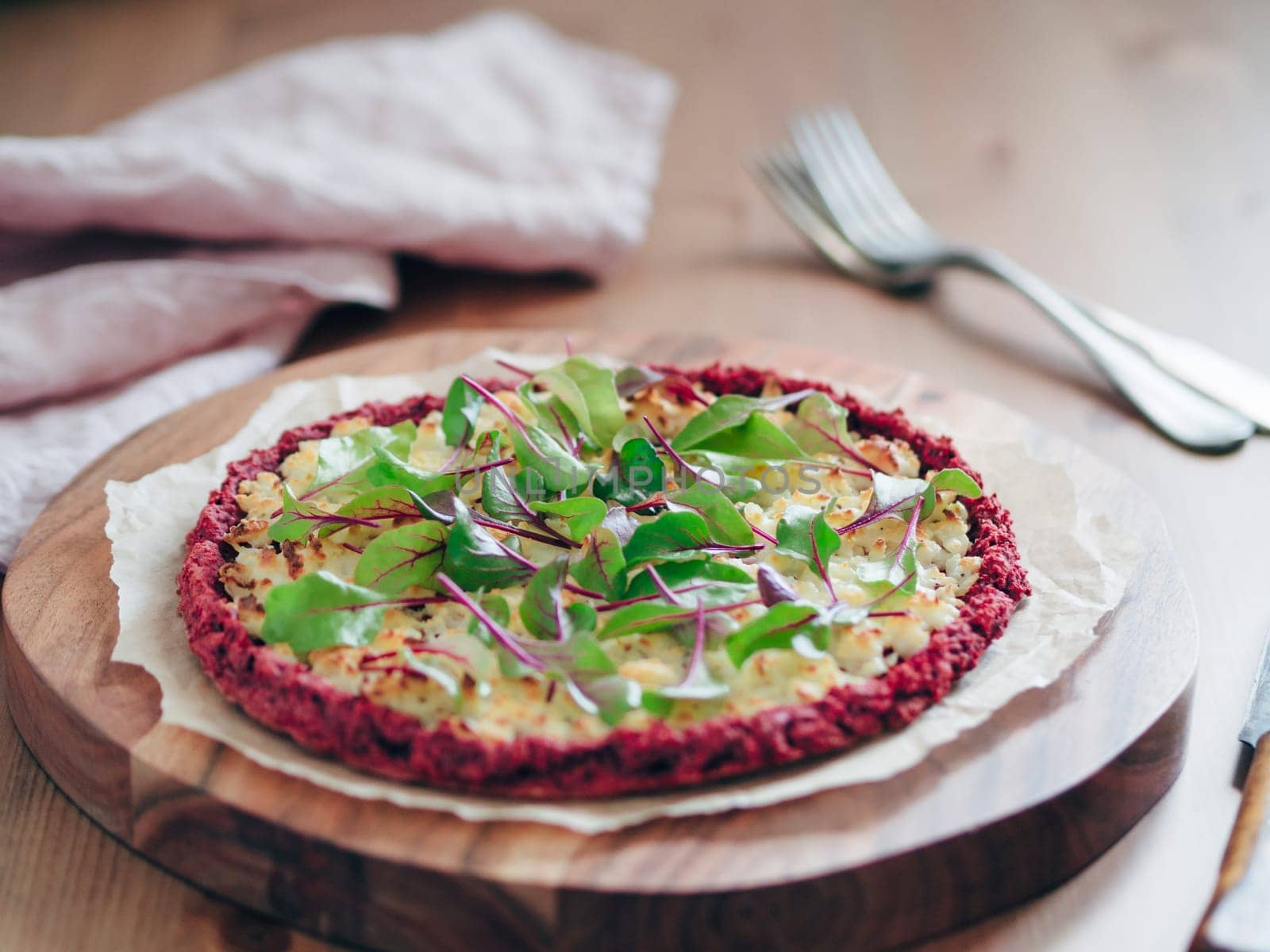 beetroot pizza crust with fresh swiss chard or mangold, beetroot leaves. Ideas and recipes for vegan snack.Egg-free pizza crust with chia seeds and wholegrain brown rice flour. Copy space. Shallow DOF