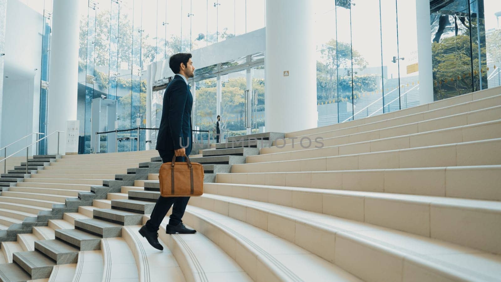 Professional business man going up the stairs. Successful man going up the stairs while explore a new thing. Represented traveling, getting a promotion, finding a new job, increasing skill. Exultant.