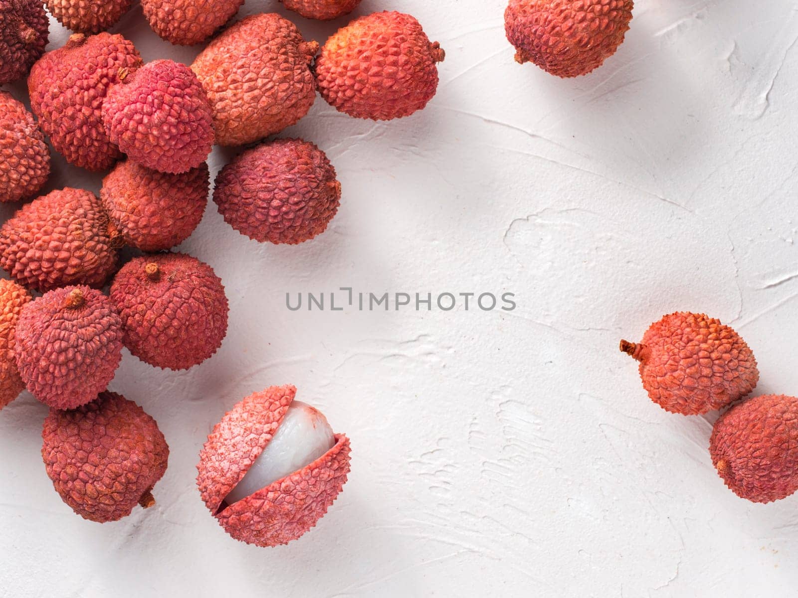 lichee fruit on white textured background. Lichee wit copy space. Top view or flat lay.