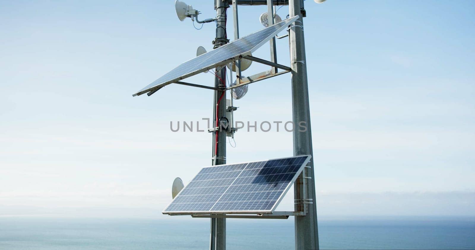 Solar panel, energy and roof with ocean, sky and horizon with sustainability, power or off grid development. Photovoltaic tech, electricity and outdoor with ecology for environment by sea in Tokyo.