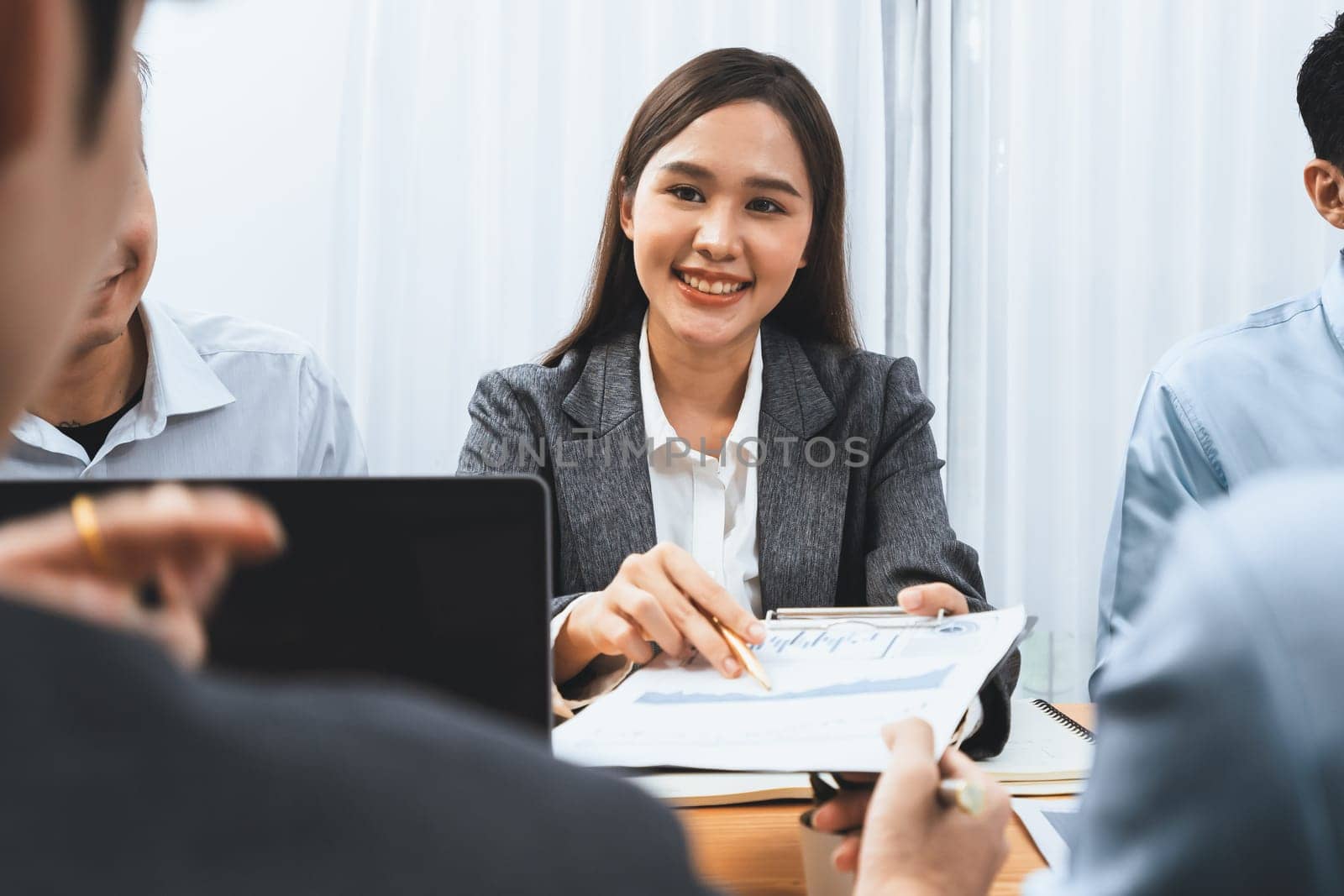 Asian analyst team use data science Fintech dashboard data paper to analyze financial report on meeting table. Data analysis for planning business strategy and marketing indication. Concord