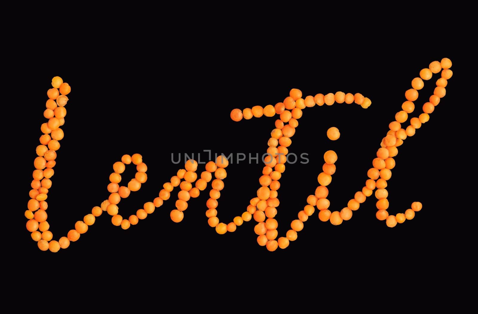 Word Lentil made from raw grains, isolated on black background with clipping path. Lentil in form of word. Healthy food and vegan concept.