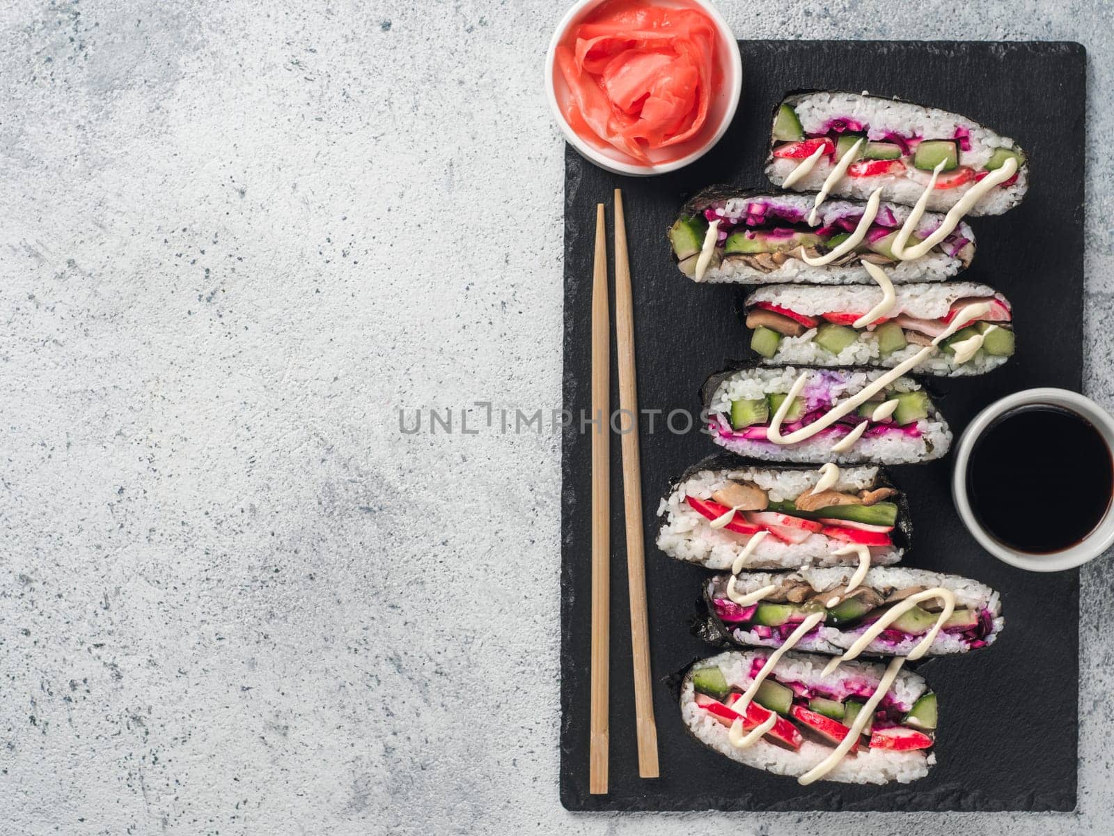 Vegan sushi sandwich onigirazu with mushrooms and vegetables.Healthy dinner recipe and idea. Colorful japan sandwich onigirazu with red cabbage,radish,cucumber,mushrooms.Trend food.Copy space.Top view