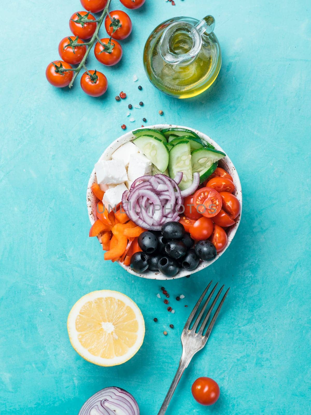 Greek Salad Bowl on blue background, copy space. Above view of Bowl Greek Salad. Trendy food. Idea, recept and concept of modern healthy food. Vertical.
