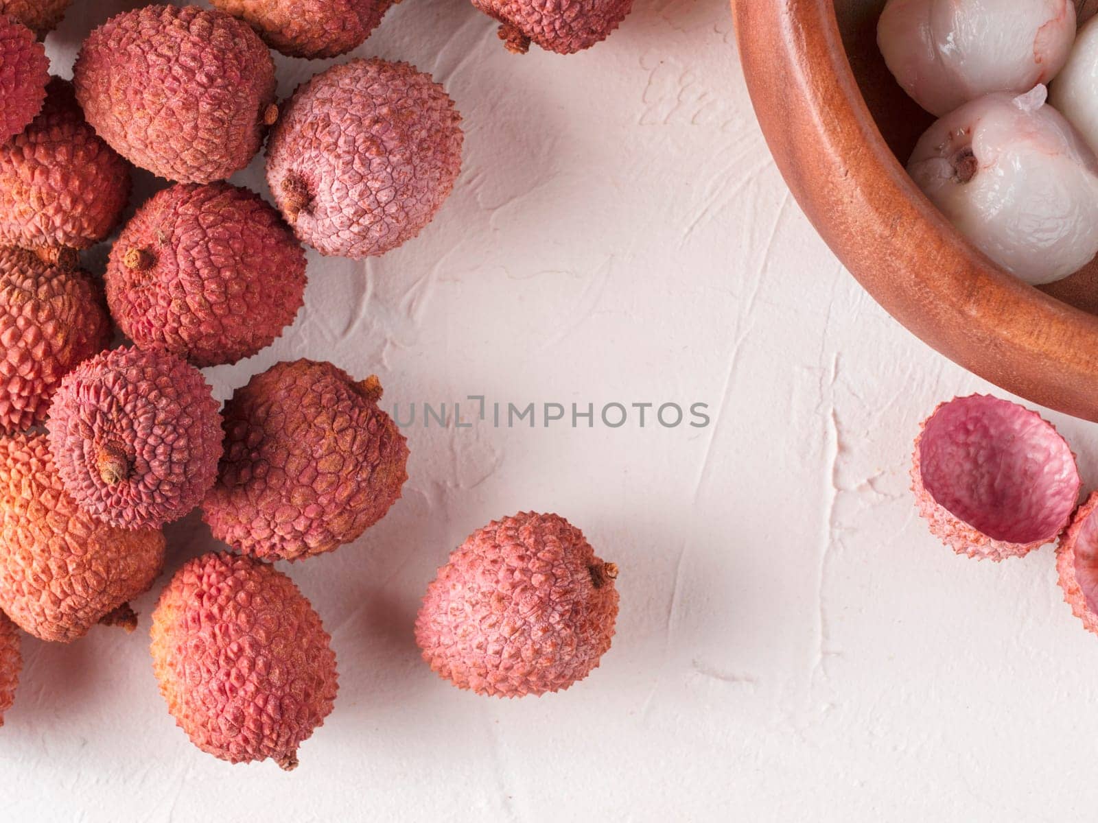 lichee fruit on white textured background. Lychee wit copy space. Top view or flat lay.