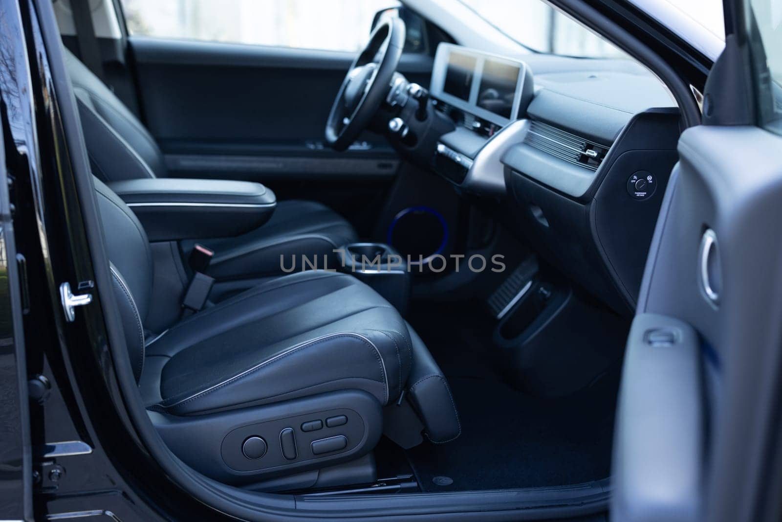 Interior of prestige modern electric car. Leather comfortable seats, dashboard and steering wheel. Car interior luxury. Cockpit with exclusive decoration by uflypro