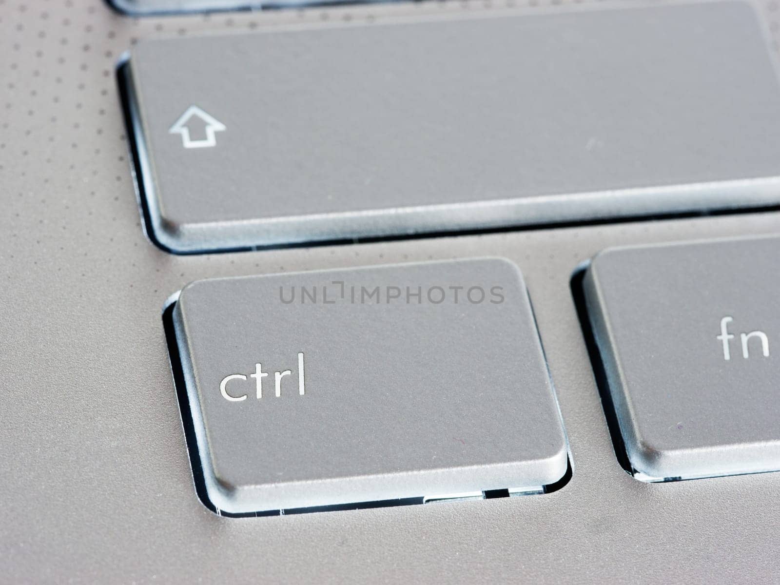 Ctrl - Control key on silver laptop keyboard. Close up