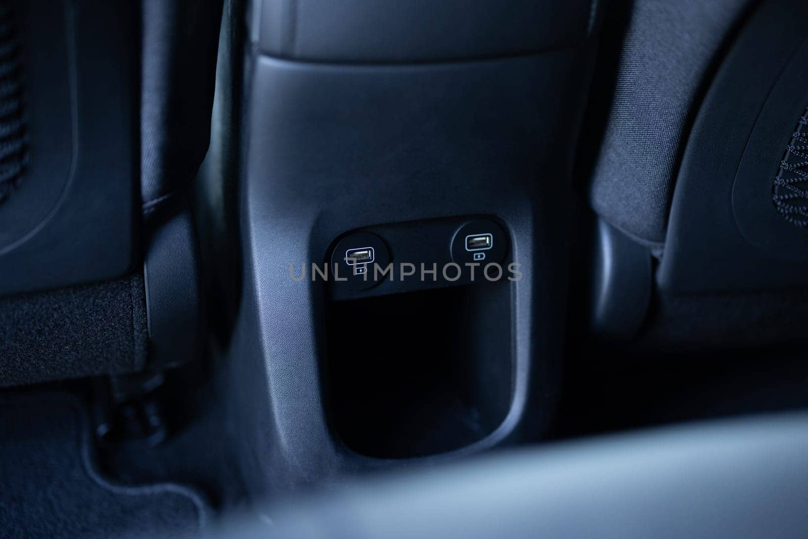 Panel in interior of a new electric car. Two USB ports for the rear seats in a passenger car. Modern electric car usb socket for charging and accessories. Car interior. by uflypro