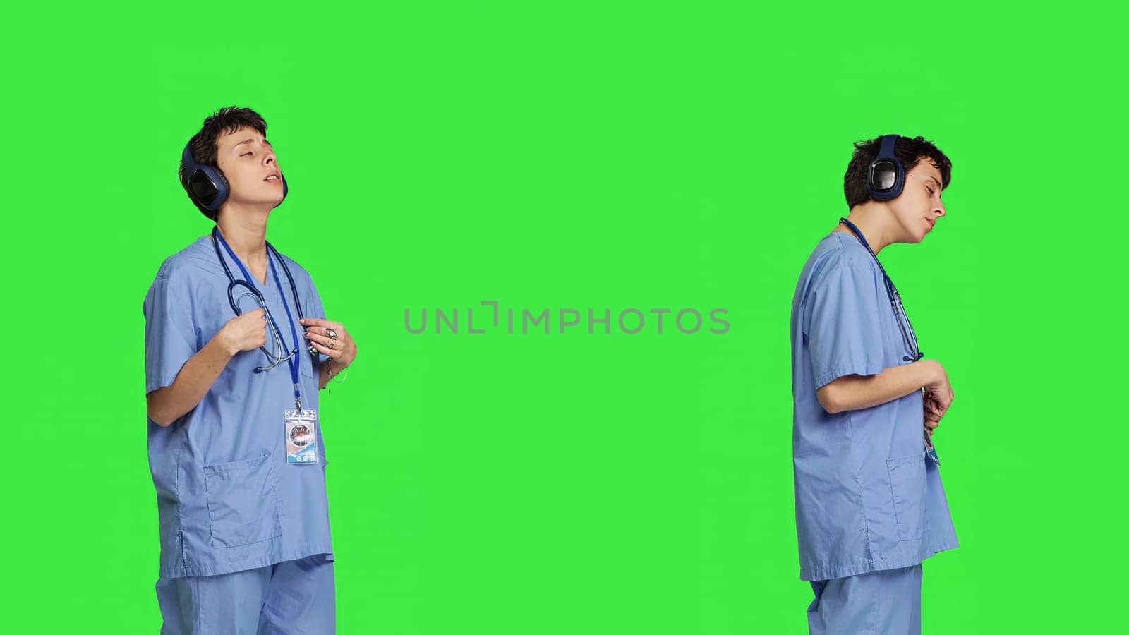 Joyful nurse singing and dancing with wireless headphones on by DCStudio