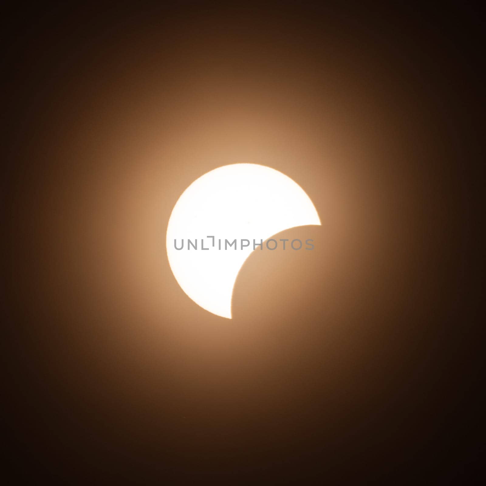 Early stage of the solar eclipse in April 2024 with the moon starting to cover the sun